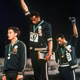US athletes Tommie Smith, center, and John Carlos with fists raised at the Summer Olympic Games in Mexico City on Oct. 16, 1968. Australian Peter Norman is at left.